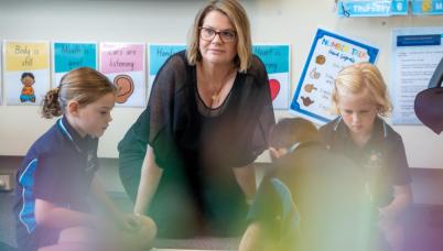 Teacher works with students