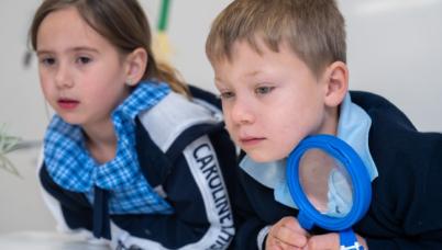 Students with magnifying glass