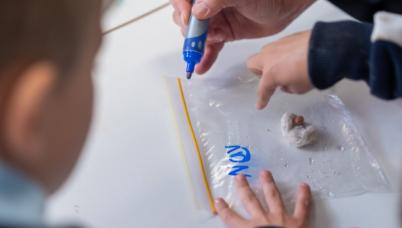 Students marking a seed in a bag