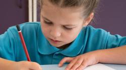 A student uses a pencil to plan their 'golden record'