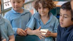 Students holding objects