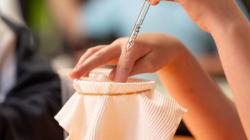 Student performs experiment by dropping water onto fabric