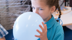 Student speaks into balloon