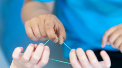 Students holding elastic band