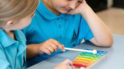 Students play xylophone