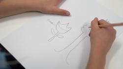 Student drawing a flower