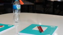A science journal and a plastic bottle prepared for an experiment