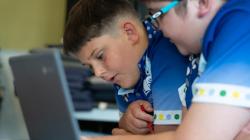 2 students collaborate on their work 