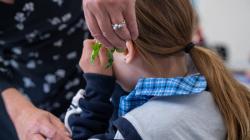 Student listens to leaves being crunched