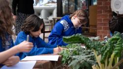 Students participate in biology classes beside a veggie patch